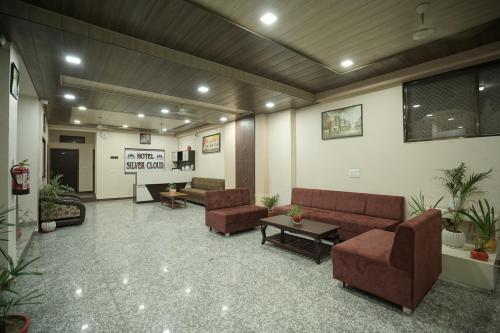 a lobby with couches and chairs and a table at Hotel Silver Cloud in Jodhpur