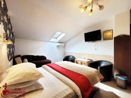 a bedroom with a bed and a flat screen tv at Vila Dorobantilor in Cluj-Napoca