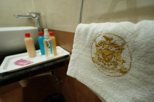 a towel with a design on it next to a sink at Hotel Silver Cloud in Jodhpur