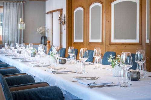 a long table in a room with chairs and wine glasses at Hotel Maier in Friedrichshafen