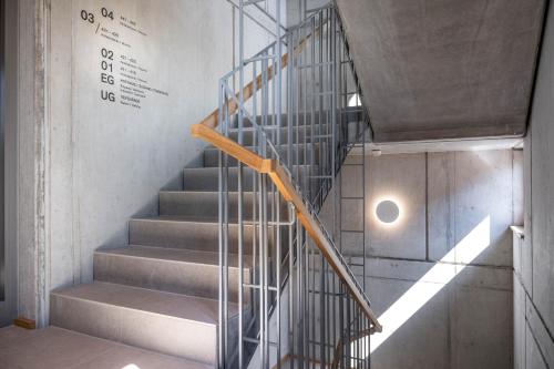 a staircase with a metal railing in a building at Hotel Maier in Friedrichshafen