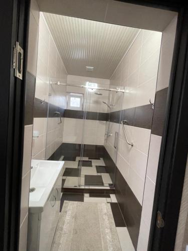 a bathroom with a shower and a sink at Роща 7 in Bishkek