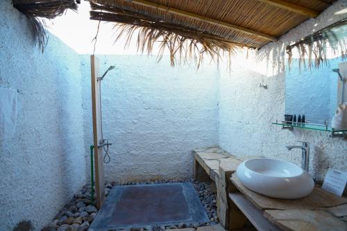 a bathroom with a sink and a toilet in it at SAMA Ras Al Jinz Resort in Sur