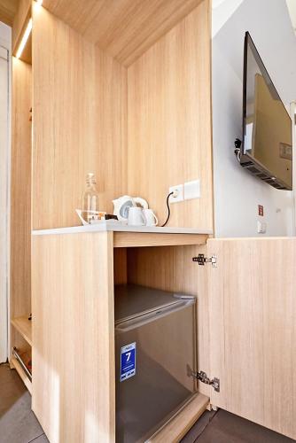 a cupboard with a sink and a television in it at Malaka Hotel Bandung in Bandung