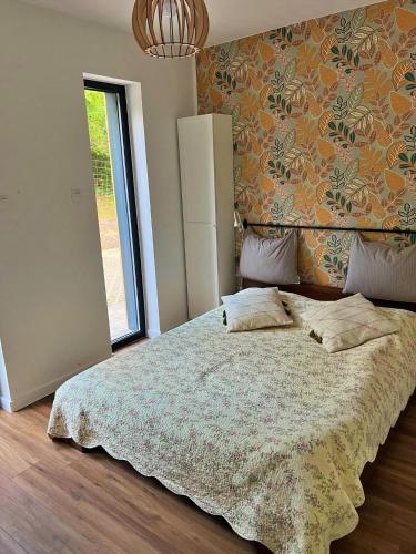 a bedroom with a large bed with a large window at Houses with a View#Sauna#Jaccuzi in Gozdowice