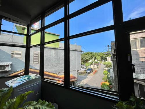 a view of a street from a window at Sun Moment 鬆貓們民宿 in Toucheng