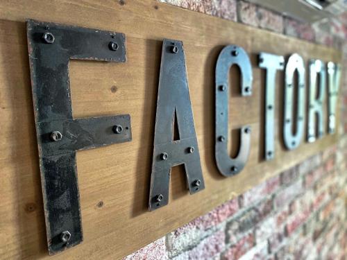 a sign that says faith hanging on a brick wall at The Loft Factory 4 Chambres Vue Garonne + Jardin in Lormont