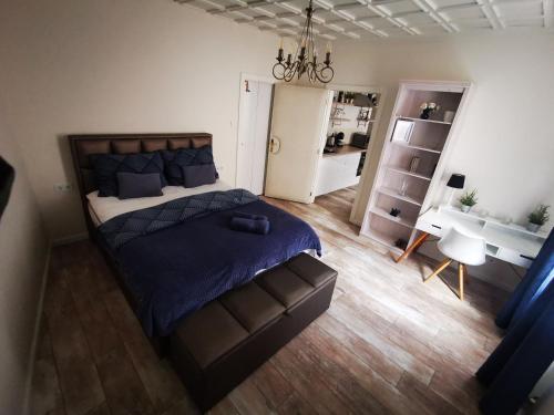 a bedroom with a bed with a blue comforter at Il Paradiso di Malasits in Győr