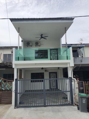 a small house with a balcony with aocrat at Voon 2 bedroom homestay in Mersing