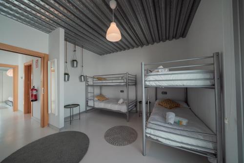 a room with two bunk beds and a table at Casa BlancadeNavarra in Fitero