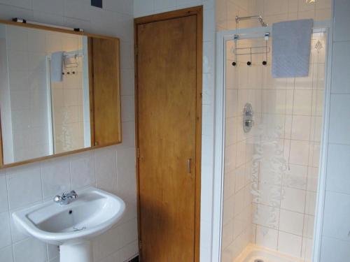 a bathroom with a sink and a shower at House by the Harbour - NC500 Route in Wick