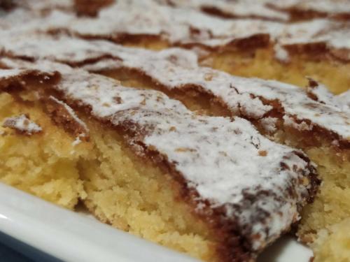 a close up of a piece of cake with powdered sugar at Hotel VIDA Ostra Marina in Sanxenxo