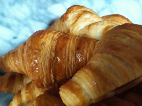 a pile of croissants sitting on a plate at Hotel VIDA Playa Paxariñas in Portonovo
