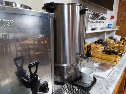 a kitchen counter with a mixer and a plate of pastries at Hotel VIDA Playa Paxariñas in Portonovo