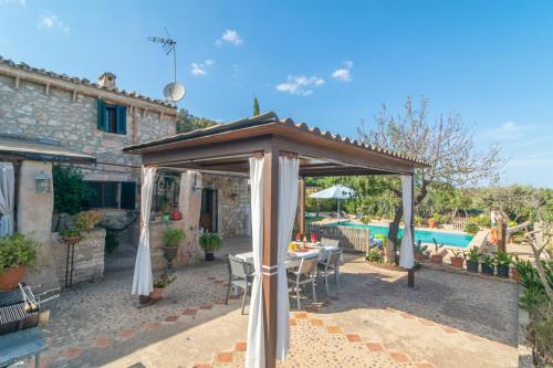 a patio with a gazebo and a pool at Finca Son Matginet 18 in Sineu