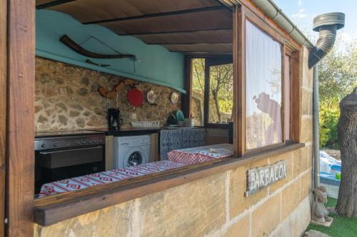 an outdoor kitchen with a stove and a window at Finca Son Matginet 18 in Sineu
