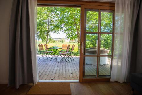 an open door to a patio with a table and chairs at Seehof direkt am See in Seeleiten