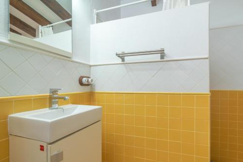 a bathroom with orange and white tiles and a sink at Finca Son Matginet 18 in Sineu