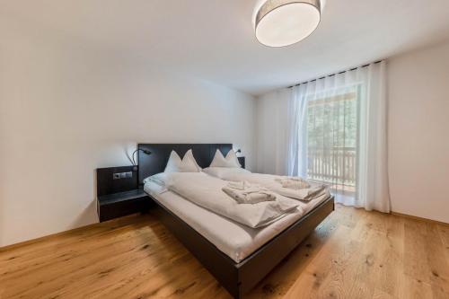 a bedroom with a bed and a large window at Apartment Ub31 One in Eggen