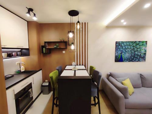 a kitchen and a living room with a table and a couch at BalkanHill2 S37 Pekovic green in Zlatibor
