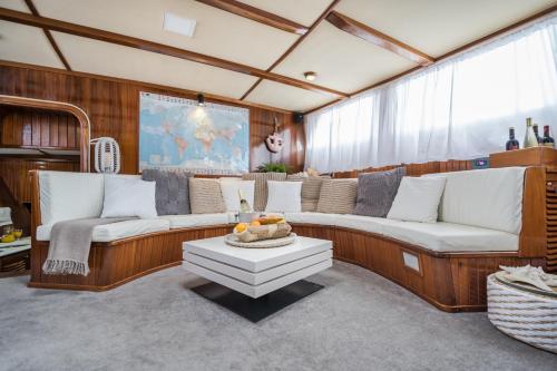a living room with two couches and a table at SPACIOUS YACHT HOTEL BARCELONA CITY CENTER 5 CABINs in Barcelona