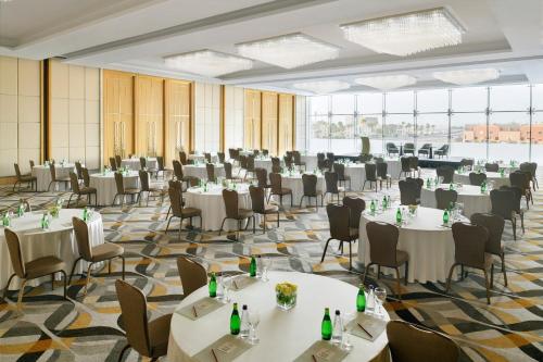 a banquet hall with white tables and chairs at Crowne Plaza - Jeddah Al Salam by IHG in Jeddah