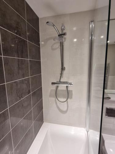 a bathroom with a shower and a sink at The Silverstone House. Comfort, Convenience and no hassle at the doorstep of Silverstone Race Circuit. in Silverstone
