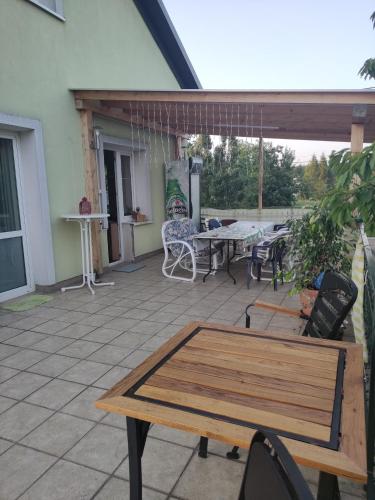 a patio with a wooden table and chairs at Homestay Stróżówka in Gorlice