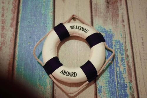 a black and white life preserver on a wall at Sailor Studio Fast Wifi Android TV at Apt Green Bay Pluit Tower F in Jakarta