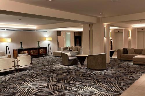 a hotel room with a lobby with couches and chairs at Hotel Cabo De Hornos in Punta Arenas