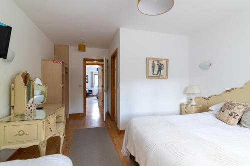 a bedroom with a bed and a dresser and a mirror at Ely House B&B in Shannonbridge