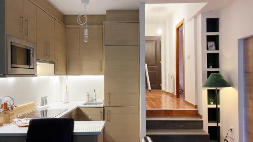 a kitchen with wooden cabinets and a stairway at Casa Alquife in Sierra Nevada