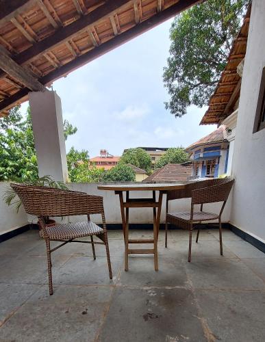 a table and two chairs on a patio at The Old Quarter Hostel in Panaji