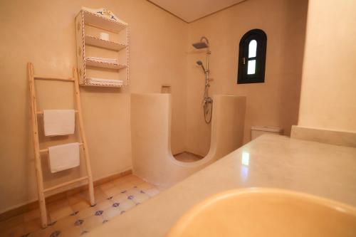 a bathroom with a shower and a sink at Tiguemine Sarah in Marrakech
