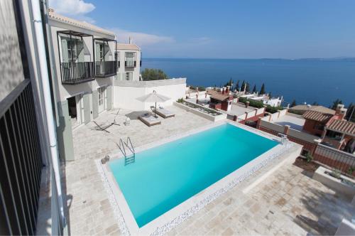 a swimming pool on the side of a building at Korypho Villas in Barbati