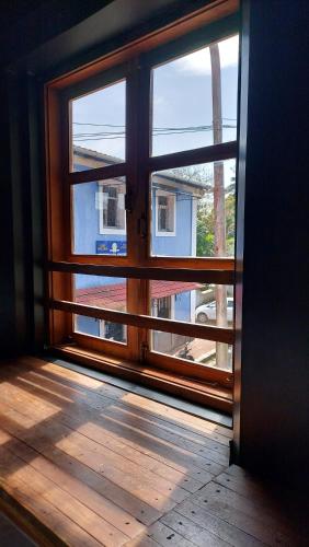 an open window with a view of a building at The Old Quarter Hostel in Panaji