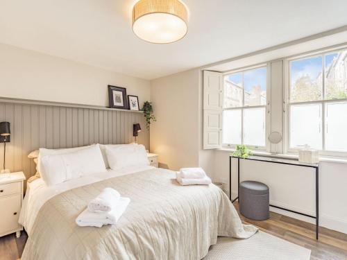 a bedroom with a large bed with towels on it at No, 2 Ness Street in Berwick-Upon-Tweed