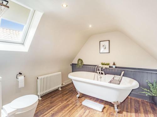 a bathroom with a white tub and a toilet at No, 2 Ness Street in Berwick-Upon-Tweed