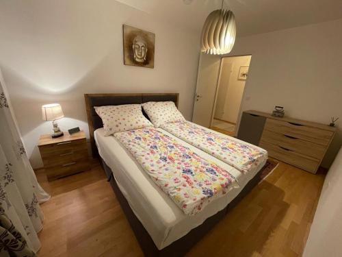 a bedroom with a bed with a floral comforter at Lovely 3 rooms apartment viena in Vienna