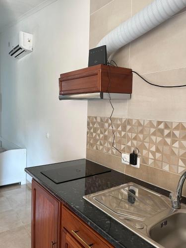 a kitchen with a sink and a counter top at Hospedaria O Castelo in Portel