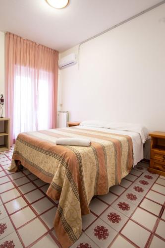 a bedroom with a large bed in a room at Hotel Costa Citara in Ischia