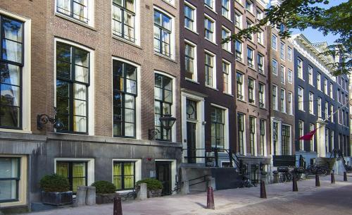 a group of buildings in front of a street at Dutch Masters Short Stay Apartments in Amsterdam