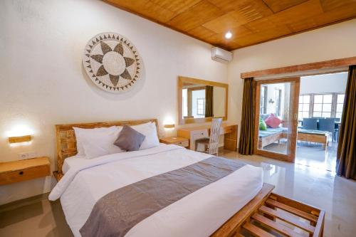 a bedroom with a bed with a clock on the wall at The Catur Villa Seminyak in Seminyak