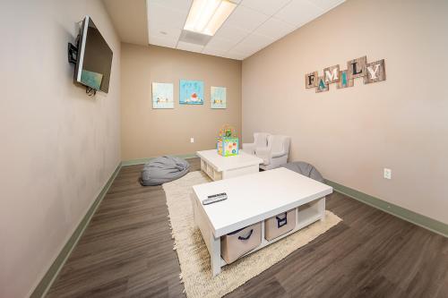 a waiting room with a white table and a chair at Hi Country 811 in Winter Park
