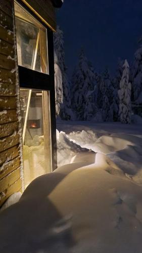 a window of a house covered in snow at night at Ekornredet (The Squirrel Nest) in Kongsberg
