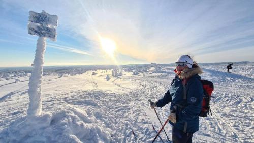 a man standing on top of a snow covered mountain at Ekornredet (The Squirrel Nest) in Kongsberg