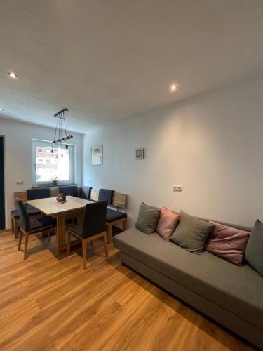 a living room with a couch and a table at Apart Egger in Schwendau