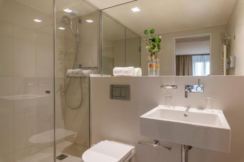 a bathroom with a toilet and a sink and a shower at 9Hotel Opera in Paris