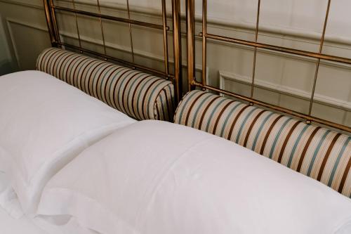 a close up of three beds in a room at Maison Matilda - Luxury Rooms in Treviso