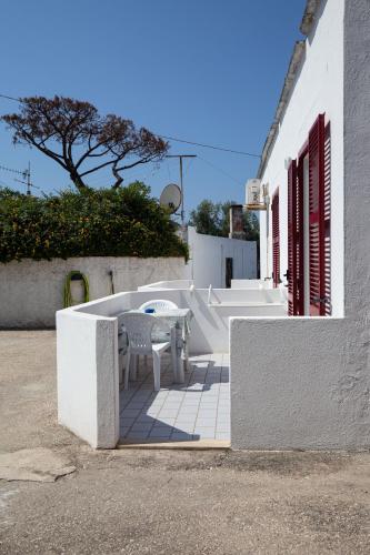 a table and chair sitting on a patio next to a building at Hotel Costa Citara in Ischia